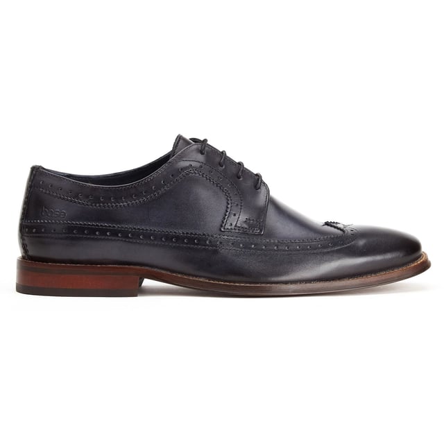 Base London Havisham Leather Men's Navy Derby Shoes Crafted from smooth leather uppers, the Havisham formal men's shoe features beautiful brogue detailing and a wing tip that runs all the way to the heel where a Base brand can be found embossed into the leather.