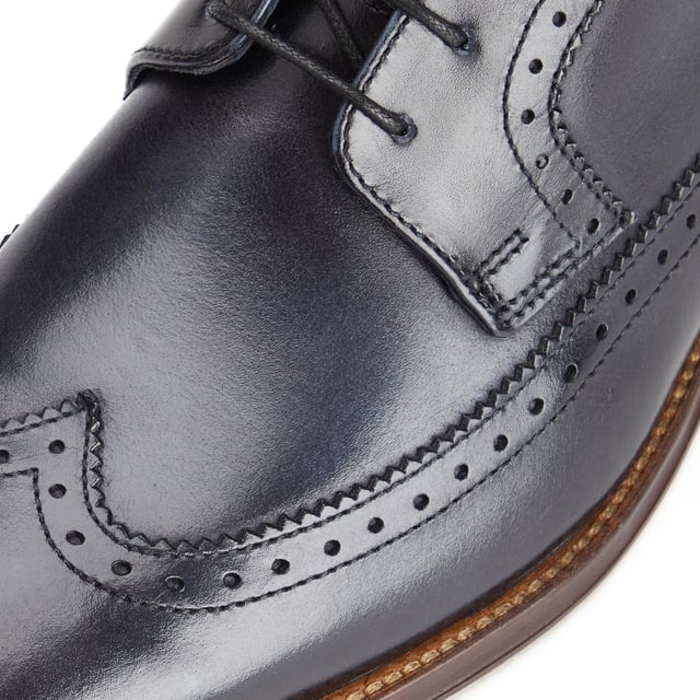 Base London Havisham Leather Men's Navy Derby Shoes Crafted from smooth leather uppers, the Havisham formal men's shoe features beautiful brogue detailing and a wing tip that runs all the way to the heel where a Base brand can be found embossed into the leather.