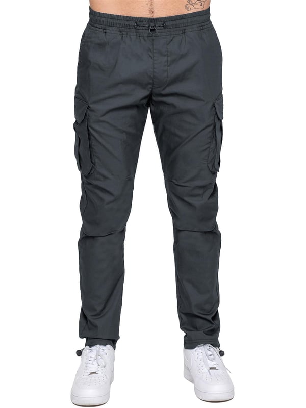 Upgrade your everyday style with the Enzo Men's Cargo Pants. Crafted from premium stretch fabric, these lightweight trousers offer a tapered leg fit for a sleek, modern look. Featuring an elasticated waistband with an adjustable toggle, they provide a customizable fit, while the adjustable toggle ankles let you tailor the look and feel. With two side slash pockets, two cargo pockets with secure Velcro fastening, and a single back welt pocket, you’ll have ample storage for essentials. Finished with an Enzo print on the cargo pocket. (649)