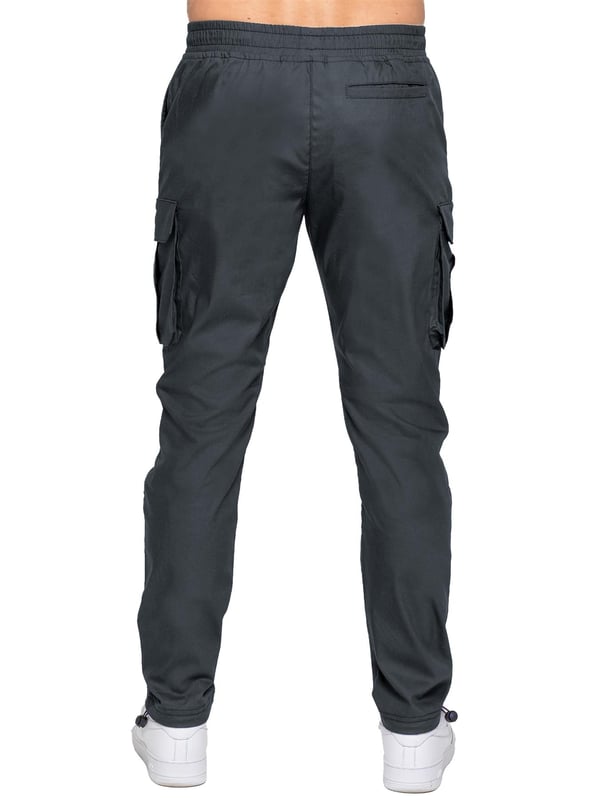 Upgrade your everyday style with the Enzo Men's Cargo Pants. Crafted from premium stretch fabric, these lightweight trousers offer a tapered leg fit for a sleek, modern look. Featuring an elasticated waistband with an adjustable toggle, they provide a customizable fit, while the adjustable toggle ankles let you tailor the look and feel. With two side slash pockets, two cargo pockets with secure Velcro fastening, and a single back welt pocket, you’ll have ample storage for essentials. Finished with an Enzo print on the cargo pocket. (649)