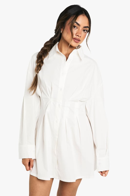Crafted from soft cotton poplin fabric for all-day comfort and breathability
        Classic collared neckline adds a sophisticated touch to this casual shirt dress
        Distinctive gathered waist detail creates a flattering silhouette
        Versatile button-through design allows for adjustable styling options
        Relaxed long sleeves with cuffs for a polished finish
    
    This shirt dress combines casual comfort with effortless style for your everyday wardrobe. The gathered waist detail creates a feminine shape whilst maintaining the relaxed feel of a classic shirt design. Style with flat loafers and a crossbody bag for university lectures or weekend brunches. For a trendy layered look, take inspiration from our model and add a checked flannel shirt tied around the waist. When the temperature drops, pair with tights, ankle boots and a chunky cardigan for a cosy autumn ensemble. Perfect for family gatherings or casual coffee dates, this Boohoo dress offers the versatility to transition from day to evening with simple accessory changes. The timeless design ensures it will remain a wardrobe staple for seasons to come.