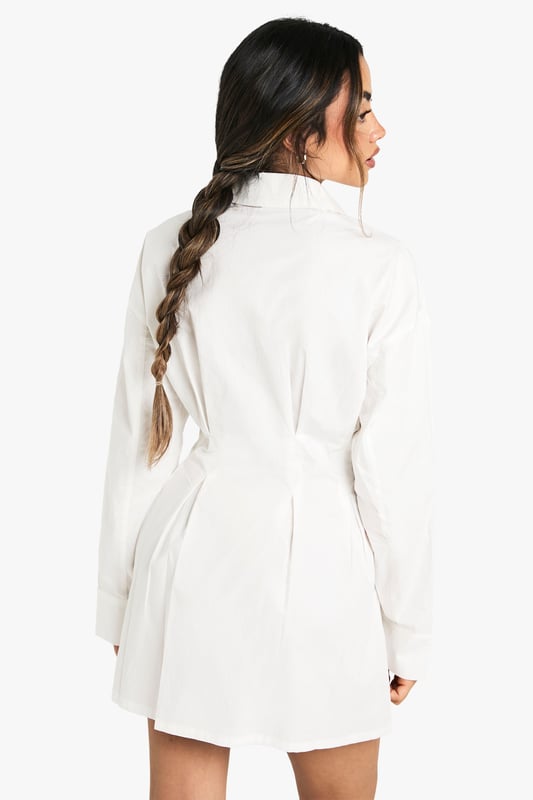 Crafted from soft cotton poplin fabric for all-day comfort and breathability
        Classic collared neckline adds a sophisticated touch to this casual shirt dress
        Distinctive gathered waist detail creates a flattering silhouette
        Versatile button-through design allows for adjustable styling options
        Relaxed long sleeves with cuffs for a polished finish
    
    This shirt dress combines casual comfort with effortless style for your everyday wardrobe. The gathered waist detail creates a feminine shape whilst maintaining the relaxed feel of a classic shirt design. Style with flat loafers and a crossbody bag for university lectures or weekend brunches. For a trendy layered look, take inspiration from our model and add a checked flannel shirt tied around the waist. When the temperature drops, pair with tights, ankle boots and a chunky cardigan for a cosy autumn ensemble. Perfect for family gatherings or casual coffee dates, this Boohoo dress offers the versatility to transition from day to evening with simple accessory changes. The timeless design ensures it will remain a wardrobe staple for seasons to come.