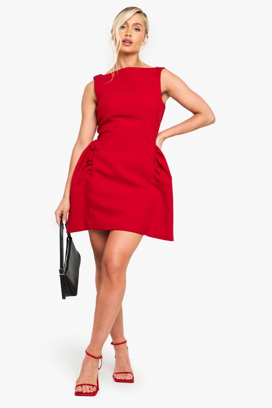 Striking Volumen skater dress with a flattering structured silhouette
        Sleeveless design with a chic slash neckline for a contemporary look
        Distinctive side pleats create dramatic volume and movement
        Short length perfect for showcasing your legs
        Clean, minimalist design makes it ideal for accessorising to suit your style
    
    Make a bold statement in this eye-catching Volumen skater dress from Boohoo. The architectural silhouette features dramatic side pleats that create stunning volume and movement as you walk, dance, or simply turn heads at your next night out. Style with strappy heels as shown for a classic going-out ensemble, or customise with statement jewellery to reflect your personal flair. This versatile piece transitions effortlessly from drinks with the girls to club nights in the city. The sleeveless cut and slash neckline offer a modern, fresh aesthetic while maintaining a sophisticated edge. Complete your look with a compact handbag and sleek updo for a night of urban adventures where you'll radiate confidence and style.