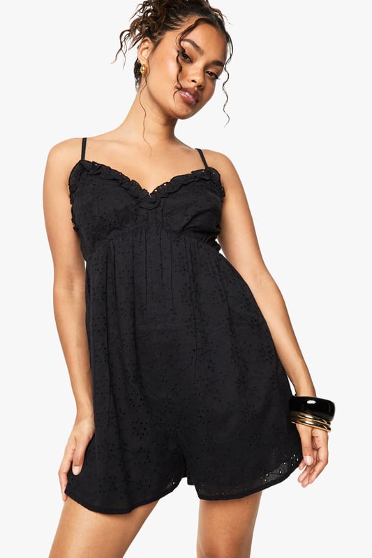 Crafted from delicate broderie anglaise fabric with intricate eyelet detailing
        Feminine V-neckline with scalloped trim for a romantic touch
        Adjustable spaghetti straps for a customised fit
        Relaxed silhouette with a flattering empire waistline
        Lightweight design perfect for warm-weather occasions
    
    This charming broderie anglaise playsuit from Boohoo combines comfort with effortless style. The delicate eyelet pattern and scalloped trim create a feminine aesthetic that works beautifully for daytime events. Style with flat sandals and stacked bangles as shown for casual gatherings, or dress up with espadrille wedges and a woven clutch for garden parties. The relaxed fit makes it ideal for family barbecues or weekend brunches, while the all-in-one design offers practicality without compromising on style. For cooler evenings, layer with a lightweight denim jacket and switch to ankle boots for versatility that transitions through the seasons. This playsuit embodies carefree summer dressing with its easy-to-wear appeal and timeless broderie fabric.