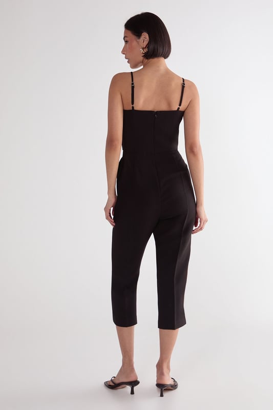 Sleek capri-length playsuit with tailored fit for a flattering silhouette
        Elegant square neckline with delicate adjustable spaghetti straps
        Practical side pockets for convenient storage of small essentials
        Cropped leg design offers a modern, sophisticated twist on classic playsuit styling
        Structured woven fabric provides comfortable stretch while maintaining shape
    
    This versatile Nasty Gal playsuit combines timeless tailoring with contemporary design for effortless style. The structured capri-length creates a refined silhouette that works beautifully for casual daytime events. Style with strappy kitten heels and statement earrings as seen on our model for family gatherings, or dress down with trendy trainers and an oversized tote for weekend brunches. The clean lines and minimalist design make this piece particularly adaptable for transitional weather-simply layer with a lightweight cardigan or cropped jacket when temperatures drop. The tailored fit flatters the waistline while the practical pockets add functionality to this chic wardrobe staple. Perfect for those seeking a balance of comfort and style for various casual occasions.