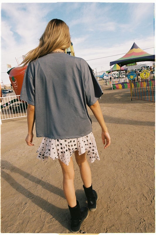 Oversized fit with relaxed dropped shoulders for effortless comfort
        Bold 'Cowboy' graphic print across the front for statement appeal
        Versatile crew neckline that works with multiple accessories
        Short sleeves with a casual, unfinished look for laid-back styling
        Cotton fabric offering breathability and softness for all-day wear
    
    Channel your inner western spirit with this Nasty Gal Cowboy Oversized Graphic T-Shirt. The relaxed silhouette creates the perfect canvas for casual daywear, whilst the statement graphic adds character to your ensemble. Style it as shown with a flirty polka dot skirt and ankle boots for a playful contrast between rugged and feminine aesthetics. For cooler days, layer with an oversized denim jacket and add chunky jewellery to enhance the look. This versatile piece transitions seamlessly from festival grounds to weekend brunches or casual shopping trips with friends. The cotton construction ensures comfort throughout the day, making it an essential addition to your casual wardrobe rotation. Pair with your favourite trainers for an effortlessly cool daytime look.