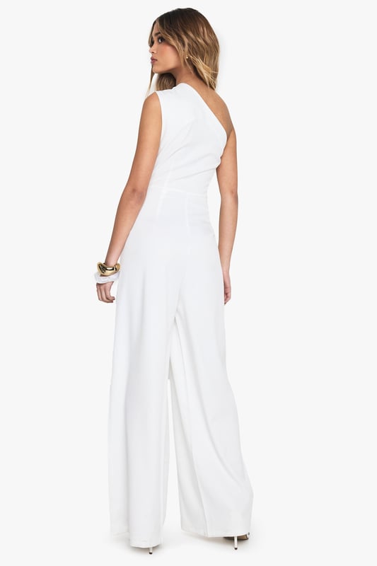 One-shoulder asymmetric neckline for a bold statement
        Wide-leg silhouette offering comfort and style
        Sleek crepe fabric for a polished look
        Single sleeve design adding a unique twist
        Floor-length cut for an elongating effect
    
    Make a striking entrance in this one-armed wide-leg jumpsuit from Boohoo. The asymmetric neckline and single sleeve design create a captivating silhouette that's sure to turn heads. Perfect for casual events or family gatherings, this versatile piece can be dressed up or down with ease. Pair with flat sandals and minimal jewellery for a relaxed daytime look, or add statement earrings and a clutch bag for evening drinks. The wide-leg cut offers both comfort and style, while the crepe fabric ensures a smooth, flattering fit. Ideal for the fashion-forward woman who wants to stand out without compromising on comfort, this jumpsuit is a must-have addition to your wardrobe. Its clean lines and modern design make it a go-to choice for those impromptu plans or when you want to feel effortlessly chic.