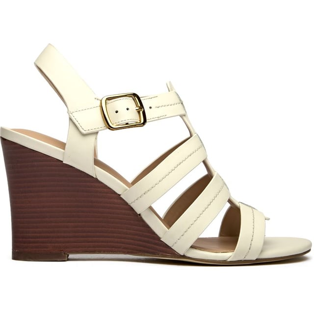 The Cole Haan Josie Fisherman brings coastal elegance to your summer wardrobe with its sophisticated 9cm wedge heel wrapped in nautical rope detailing. Crafted from supple white leather with a secure buckle closure, this sandal features a luxuriously cushioned insole for all-day comfort. The wood veneer edged sole adds an artisanal touch that elevates any outfit from beachside brunches to rooftop dinners.
