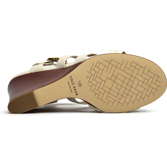 The Cole Haan Josie Fisherman brings coastal elegance to your summer wardrobe with its sophisticated 9cm wedge heel wrapped in nautical rope detailing. Crafted from supple white leather with a secure buckle closure, this sandal features a luxuriously cushioned insole for all-day comfort. The wood veneer edged sole adds an artisanal touch that elevates any outfit from beachside brunches to rooftop dinners.