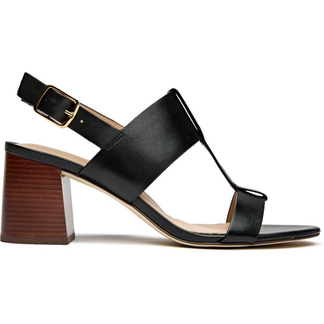 The Cole Haan Josie T-Strap elevates summer sophistication with its sleek black leather construction and striking wood-trimmed sole. At 7cm, the wedge heel delivers confident height while the cushioned insole ensures all-day comfort. The classic T-strap silhouette secured with a refined buckle closure makes this sandal an effortless transition from boardroom to bistro.