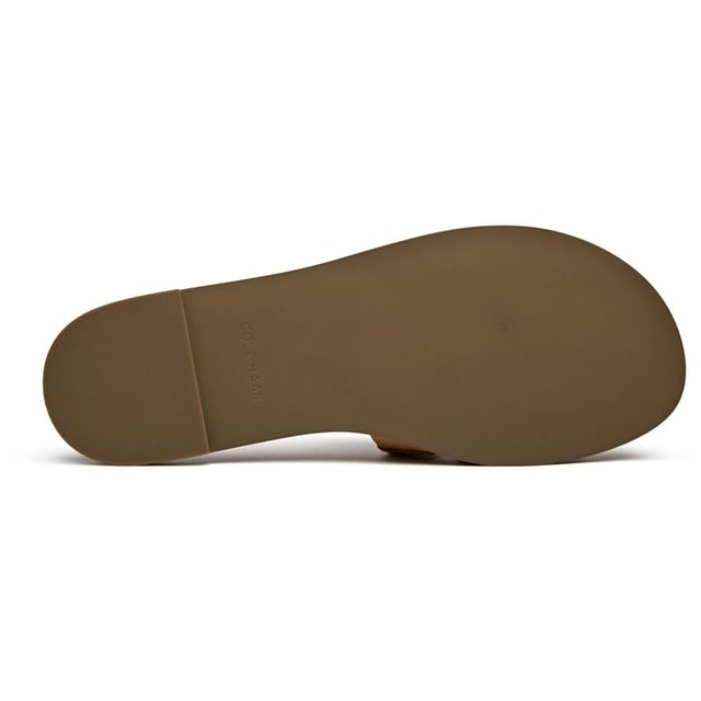 Effortless sophistication meets everyday comfort in these tan leather slides. The Cole Haan Flynn Fishman features a supple leather upper with a classic buckle detail that adds just the right touch of refinement. With a cushioned insole that cradles your feet and a durable synthetic sole, these versatile flats transition seamlessly from morning errands to evening gatherings.