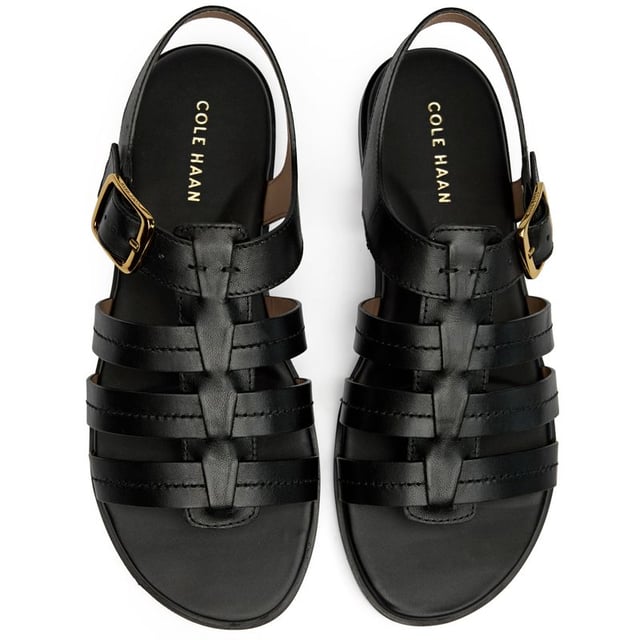 These sleek black leather slides bring effortless sophistication to your summer wardrobe. The Flynn Fisherman features premium leather construction with a comfortable cushioned insole that cradles your feet through long days. A classic buckle closure adds both style and adjustability, while the durable synthetic sole provides reliable traction. Perfect for everything from weekend brunches to casual office days.