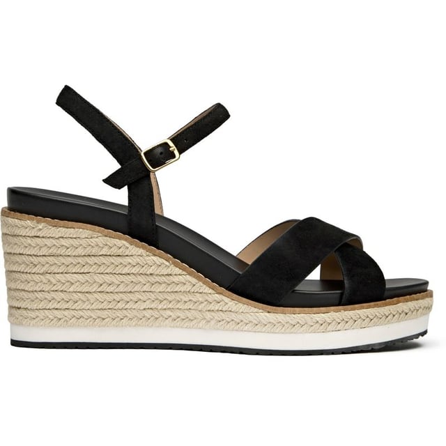 Cole Haan Silvee Sandals The Cole Haan Silvee brings sophisticated elevation to warm-weather dressing with its luxurious nubuck upper and distinctive rope-edged sole. This black espadrille sandal features a secure buckle closure and generous 9cm heel that adds statuesque height while maintaining comfort through its cushioned insole. The rubber and rope sole construction delivers both style and durability, making it perfect for everything from weekend brunches to evening gatherings.