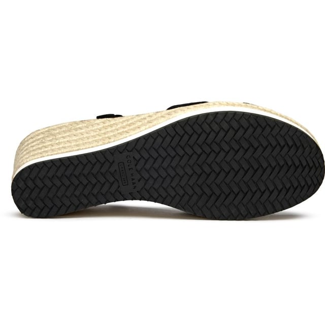 Cole Haan Silvee Sandals The Cole Haan Silvee brings sophisticated elevation to warm-weather dressing with its luxurious nubuck upper and distinctive rope-edged sole. This black espadrille sandal features a secure buckle closure and generous 9cm heel that adds statuesque height while maintaining comfort through its cushioned insole. The rubber and rope sole construction delivers both style and durability, making it perfect for everything from weekend brunches to evening gatherings.