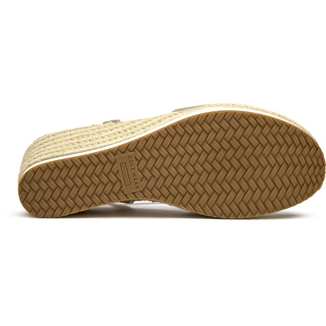 The Cole Haan Silvee transforms the classic espadrille with luxurious gold nubuck and a statement 9cm heel that elevates any summer look. Its rope-edged sole maintains that quintessential Mediterranean charm while the cushioned insole ensures all-day comfort. The secure buckle closure and premium rubber-rope construction make these sandals as practical as they are stunning, perfect for rooftop dinners or seaside strolls.
