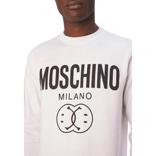 Elevate your wardrobe with the Moschino Double Smiley White Jumper, a perfect blend of playful design and premium comfort. Crafted from soft, high-quality fabric, this jumper features Moschino's iconic double smiley graphic that adds a fun, contemporary edge to your look. Its crisp white color makes it versatile for any casual occasion, while the relaxed fit ensures all-day comfort. Whether paired with jeans or layered under a jacket, this jumper effortlessly combines style and ease, making it a must-have statement piece for those who appreciate bold fashion with a lighthearted twist.1001 WHITE JUMPER MALE, Made in Portugal, 100% Cotton