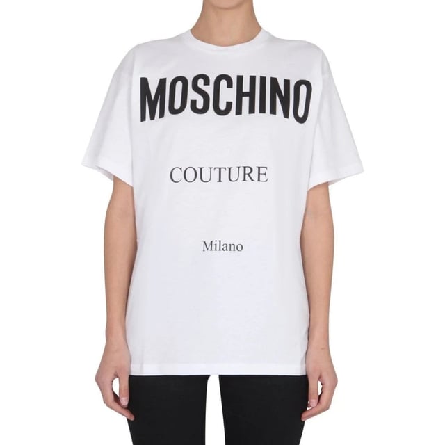 Elevate your wardrobe with the Moschino Couture Milano White T-Shirt, a perfect blend of luxury and casual style. Crafted with premium materials, this white tee offers exceptional comfort and durability, making it ideal for everyday wear. Its sleek design and subtle branding add a touch of sophistication, allowing you to effortlessly transition from day to night. Whether paired with jeans or layered under a blazer, this versatile piece enhances any outfit with a chic, modern edge. Invest in timeless elegance and make a bold fashion statement with Moschino's signature quality and style. Made in Portugal, 100% Cotton