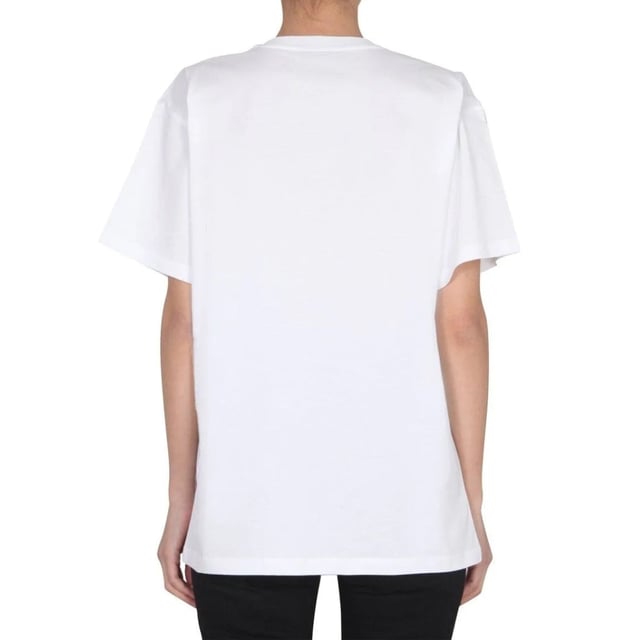 Elevate your wardrobe with the Moschino Couture Milano White T-Shirt, a perfect blend of luxury and casual style. Crafted with premium materials, this white tee offers exceptional comfort and durability, making it ideal for everyday wear. Its sleek design and subtle branding add a touch of sophistication, allowing you to effortlessly transition from day to night. Whether paired with jeans or layered under a blazer, this versatile piece enhances any outfit with a chic, modern edge. Invest in timeless elegance and make a bold fashion statement with Moschino's signature quality and style. Made in Portugal, 100% Cotton