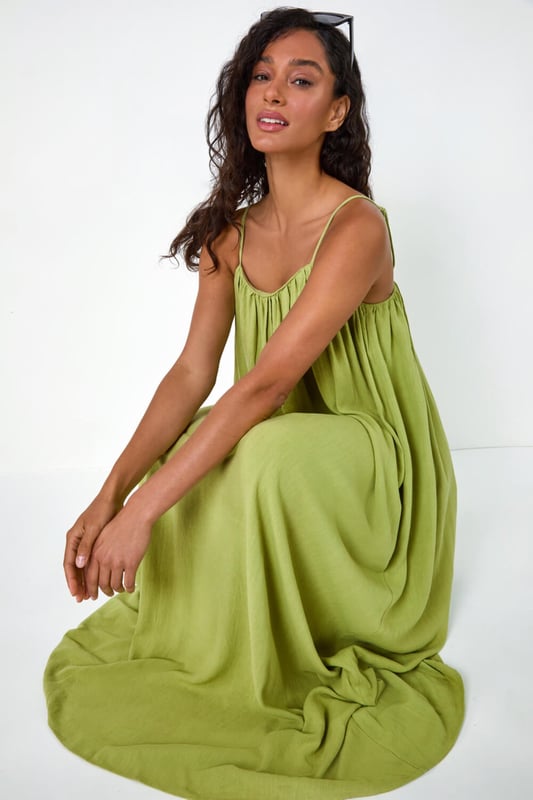 Dusk Woven Strappy Maxi Dress from Roman. Float effortlessly through the Spring Summer season in our trendy strappy maxi dress. Falling to a comfortable maxi length, this dress features a flowy A-line shape and sleeveless silhouette. Cut from a smooth woven fabric with a touch of linen, it will keep you airy and light. Perfect for your beach getaway or casual days out, style this versatile dress with strappy sandals and a light jacket for a laid-back look!