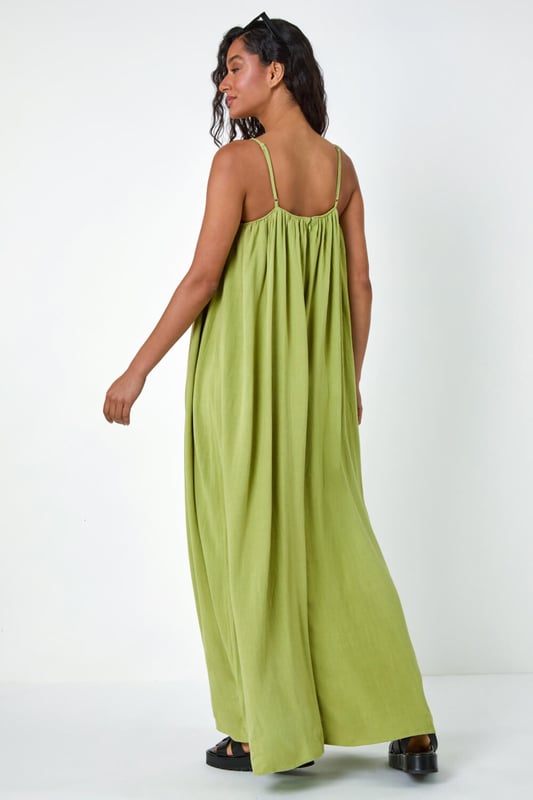 Dusk Woven Strappy Maxi Dress from Roman. Float effortlessly through the Spring Summer season in our trendy strappy maxi dress. Falling to a comfortable maxi length, this dress features a flowy A-line shape and sleeveless silhouette. Cut from a smooth woven fabric with a touch of linen, it will keep you airy and light. Perfect for your beach getaway or casual days out, style this versatile dress with strappy sandals and a light jacket for a laid-back look!