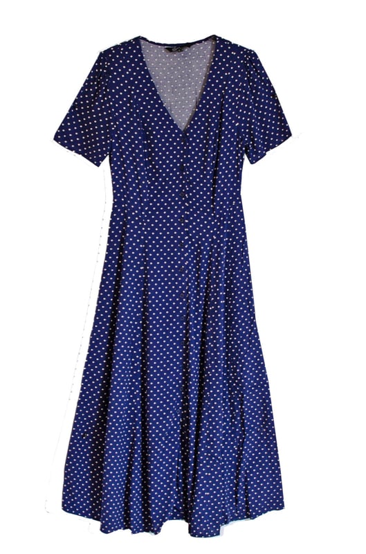The Ellen tea dress is made entirely from responsible viscose that drapes like a dream. A little bit vintage-inspired. A navy polka dot print, swishy a-line cut and delicate line of buttons add to the look. Finish yours with gold necklaces.
 These are very slight seconds - does not affect wearability.

48-49" Shoulder to Hem.

As clearance stock they may not be in original packaging.