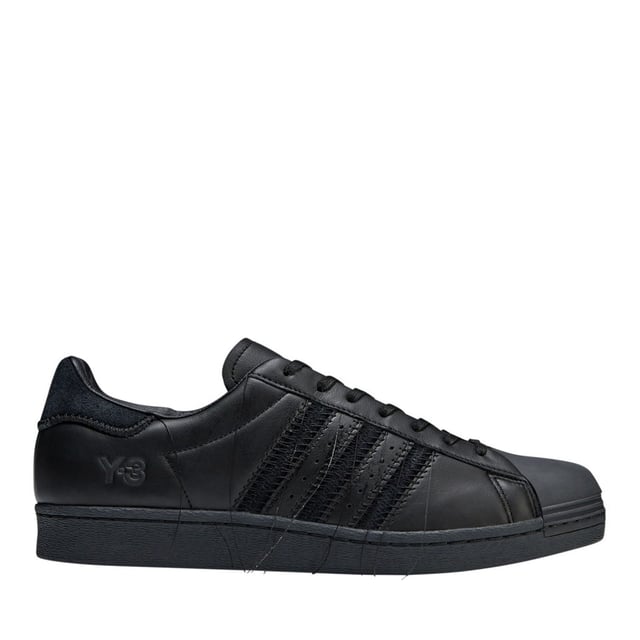 Y-3 Superstar Trainers in blackArguably one of adidas' most celebrated trainers  the iconic Superstar Shoes get an update from Y-3. They're fabricated in premium leather and suede materials. In a nod to the Japanese technique of Sashiko stitching  the trainers have accentuated and tonal stitching around the eyestay  heel tab  midsole and the signature 3-Stripes  with all threads intentionally hanging loosely. The classic rubber shell toe stands out even more with thick embroidery where the original lines usually are.- Y-3's take on the adidas Superstar shoes  inspired by traditional Sashiko stitching.- Lace closure- Leather and suede upper- Leather and canvas lining- Rubber outsole- Embroidered shell toe- Y-3 logo- Ref: HP3127