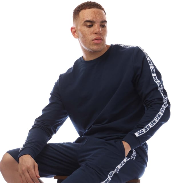 Mens DKNY Sea Dogs Long Sleeve Top in navy.- Crewneck.- Ribbed cuffs and hem.- DKNY branded ribbon down the arms.- Regular fit.- 100% Cotton.- Ref: N56806DKYNV