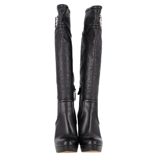 VINTAGE, RRP AS NEW
 Make a bold statement with the Gucci Guccissima Platform Knee-High Boots, crafted in sleek black leather and embossed with the iconic monogram. The dramatic platform and towering heel elevate any outfit—literally and stylistically—while exuding luxury from every angle. **Styling Tip:** Let the boots shine by pairing them with a fitted mini dress or leather skirt for an edgy, fashion-forward look.

Gucci Guccissima Platform Knee-High Boots in Black Leather

Condition: Very good
Signs of wear: Minor markings, Lightly used but very well maintained. Minor mark at soles & creasing, light scuffing at the soles and heels.
Packaging: None
Color: Black
Material: Leather | leather
Size: IT | 38.5
Measurements: Heel height: 120; Insole length: 270
SKU: NAPPUGBSH489764W