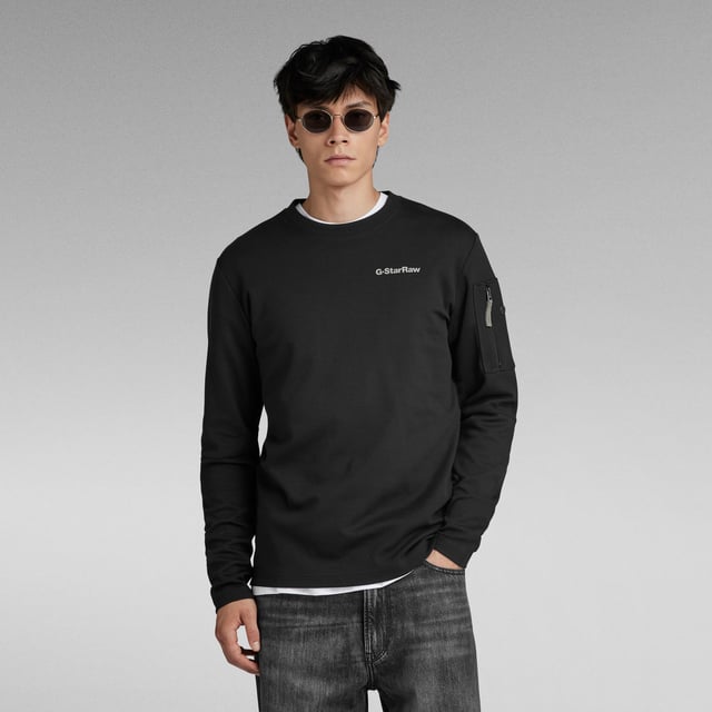Round neck, ribbed. Long sleeves- seam across the elbow. Zip pocket at the upper sleeve. Straight hem. G-Star RAW graphic print at the chest. Lighter weight sweater, comfortable as a T-shirt. No closure. This organic cotton jersey offers a subtle structure. Jersey knit. Loose