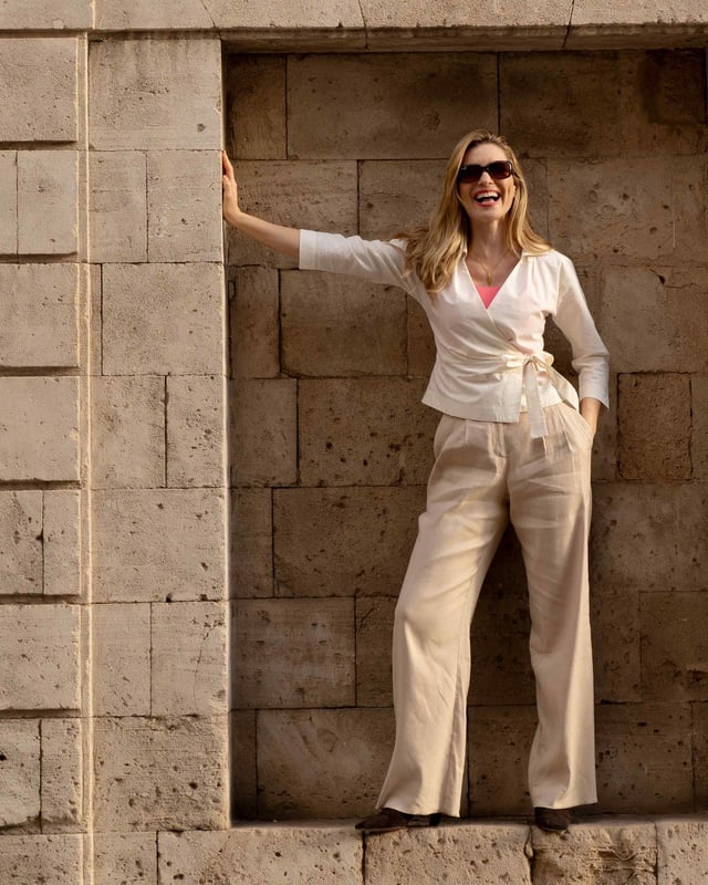 Embrace sophistication with this fitted wrap-style shirt, perfect for day-to-evening occasions. Featuring 3/4 length sleeves, pleated shoulders, cuffs, and adjustable side ties, it offers a flattering silhouette.