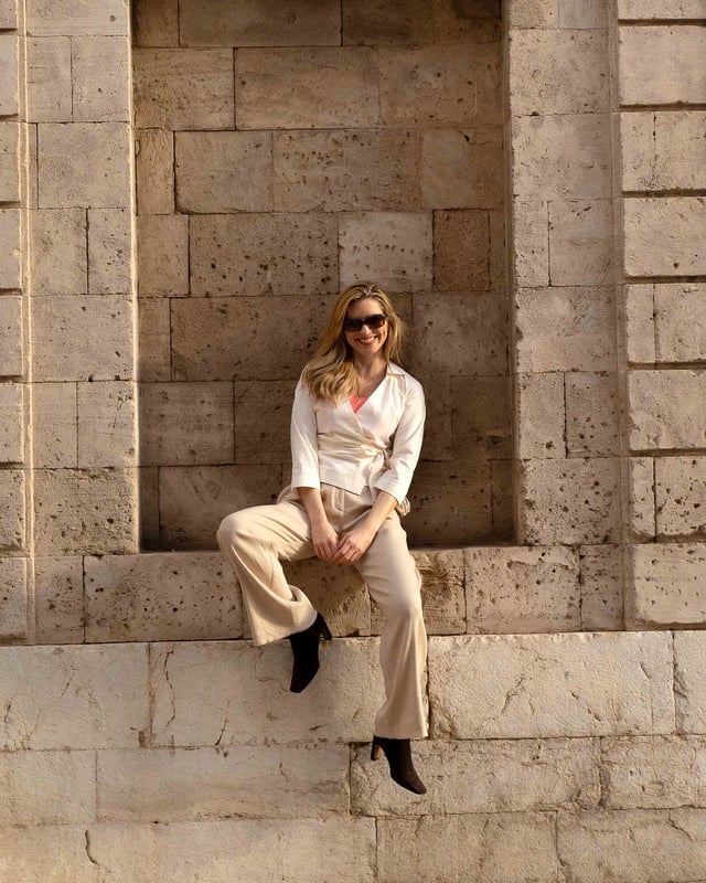Embrace sophistication with this fitted wrap-style shirt, perfect for day-to-evening occasions. Featuring 3/4 length sleeves, pleated shoulders, cuffs, and adjustable side ties, it offers a flattering silhouette.