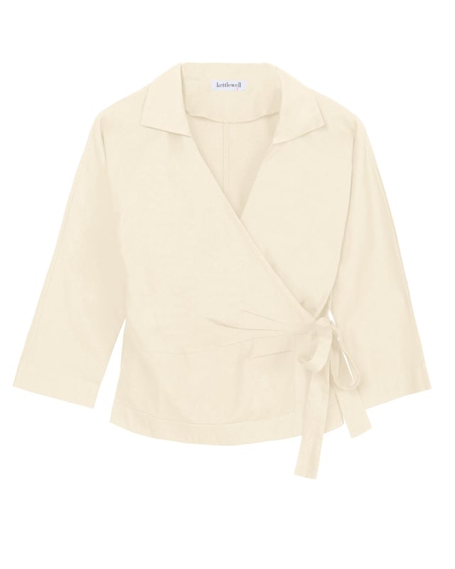 Embrace sophistication with this fitted wrap-style shirt, perfect for day-to-evening occasions. Featuring 3/4 length sleeves, pleated shoulders, cuffs, and adjustable side ties, it offers a flattering silhouette.