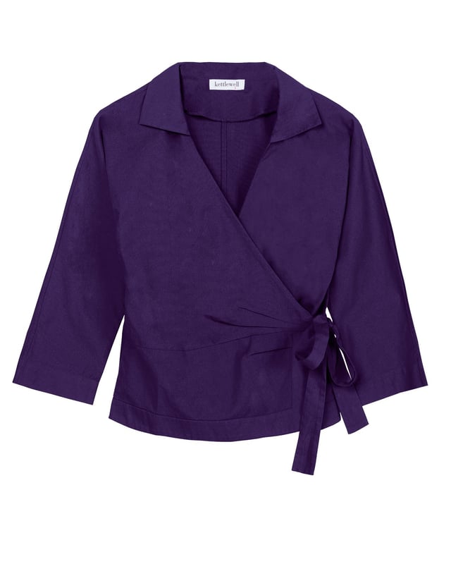 Embrace sophistication with this fitted wrap-style shirt, perfect for day-to-evening occasions. Featuring 3/4 length sleeves, pleated shoulders, cuffs, and adjustable side ties, it offers a flattering silhouette.