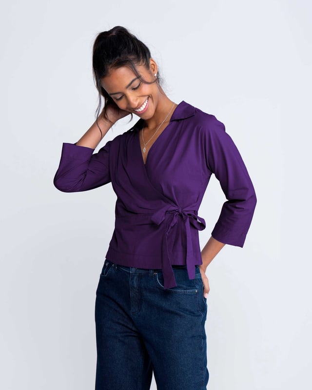 Embrace sophistication with this fitted wrap-style shirt, perfect for day-to-evening occasions. Featuring 3/4 length sleeves, pleated shoulders, cuffs, and adjustable side ties, it offers a flattering silhouette.
