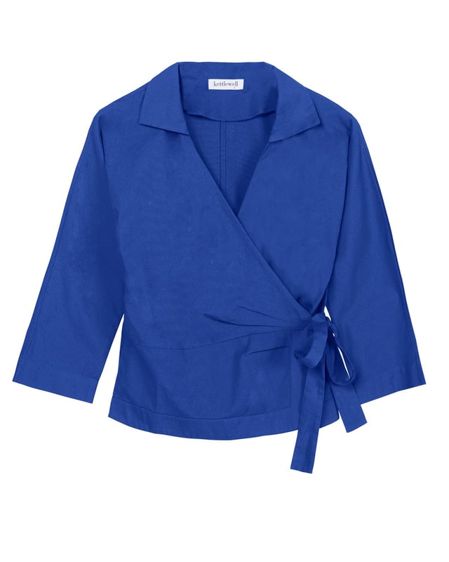 Embrace sophistication with this fitted wrap-style shirt, perfect for day-to-evening occasions. Featuring 3/4 length sleeves, pleated shoulders, cuffs, and adjustable side ties, it offers a flattering silhouette.