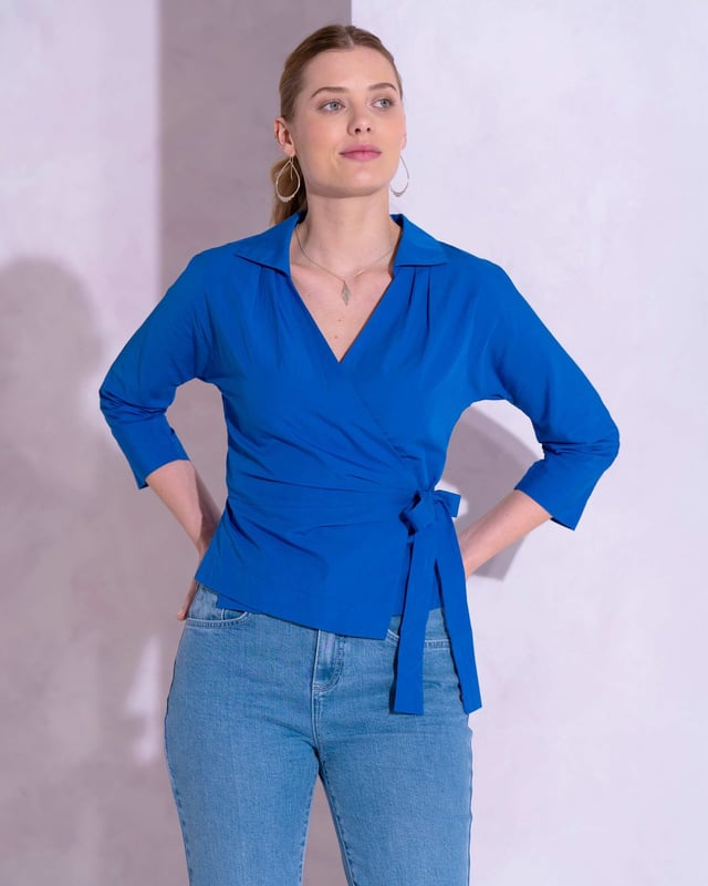 Embrace sophistication with this fitted wrap-style shirt, perfect for day-to-evening occasions. Featuring 3/4 length sleeves, pleated shoulders, cuffs, and adjustable side ties, it offers a flattering silhouette.