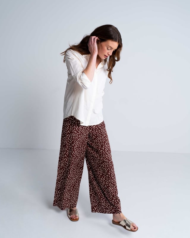Elevate your wardrobe with these versatile print trousers, perfect for transitioning from day to evening with effortless style. The wide-leg design, straight from thigh to hem, offers a flattering silhouette for all body types. A flat front waistband with a discreet back elastic panel ensures a comfortable, flexible fit. Part of the chic Joni Spot collection, these full-length trousers are an updated version of our popular Zoe Print design.