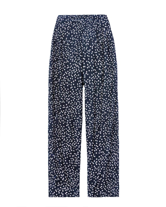 Joni Print Trousers Elevate your wardrobe with these versatile print trousers, perfect for transitioning from day to evening with effortless style. The wide-leg design, straight from thigh to hem, offers a flattering silhouette for all body types. A flat front waistband with a discreet back elastic panel ensures a comfortable, flexible fit. Part of the chic Joni Spot collection, these full-length trousers are an updated version of our popular Zoe Print design.