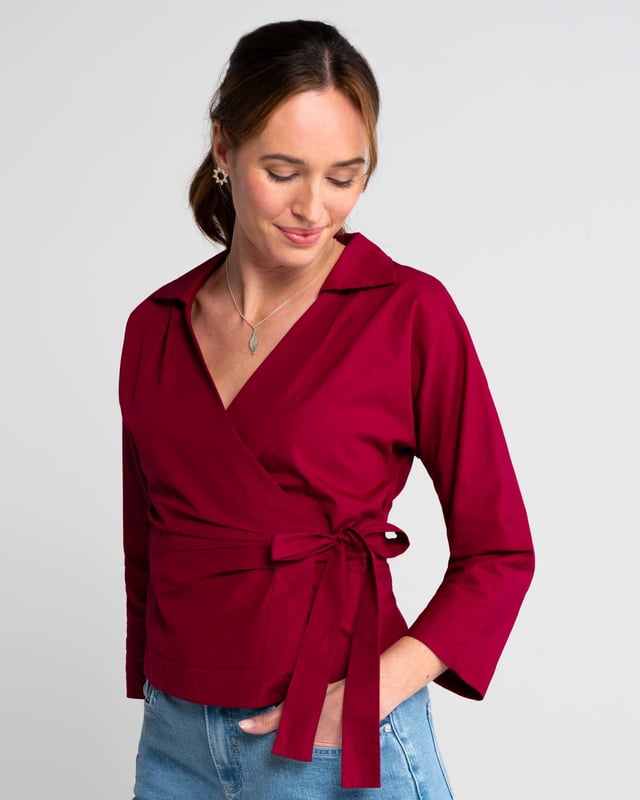 Embrace sophistication with this fitted wrap-style shirt, perfect for day-to-evening occasions. Featuring 3/4 length sleeves, pleated shoulders, cuffs, and adjustable side ties, it offers a flattering silhouette.