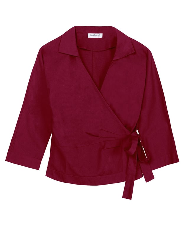 Embrace sophistication with this fitted wrap-style shirt, perfect for day-to-evening occasions. Featuring 3/4 length sleeves, pleated shoulders, cuffs, and adjustable side ties, it offers a flattering silhouette.