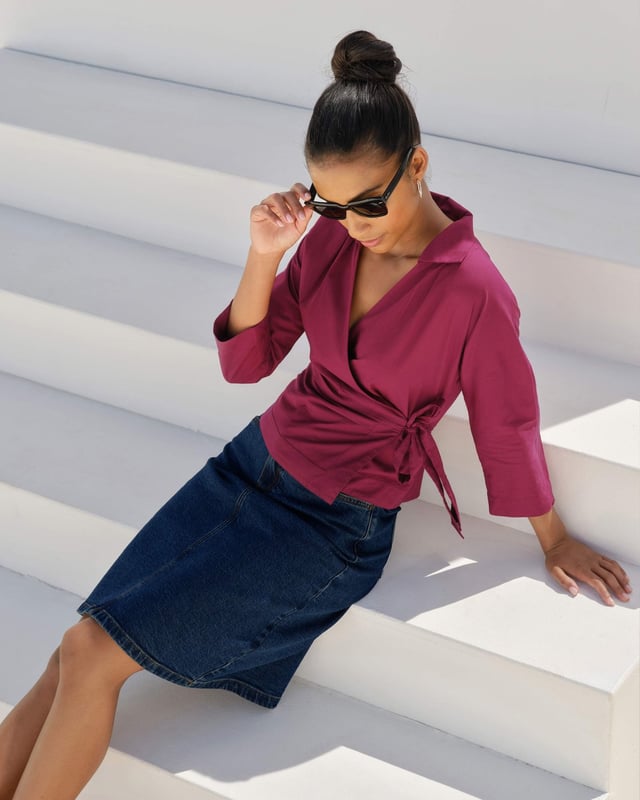 Embrace sophistication with this fitted wrap-style shirt, perfect for day-to-evening occasions. Featuring 3/4 length sleeves, pleated shoulders, cuffs, and adjustable side ties, it offers a flattering silhouette.