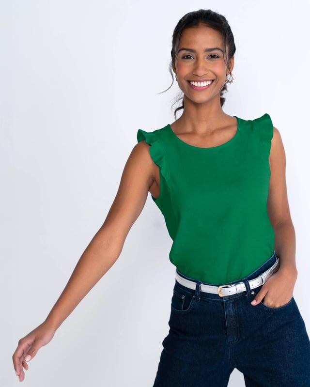 This sleeveless top features a neat neckline and charming frill shoulder detail, perfect for your holiday wardrobe. The regular fit ensures comfort, while the elegant design adds a touch of femininity.