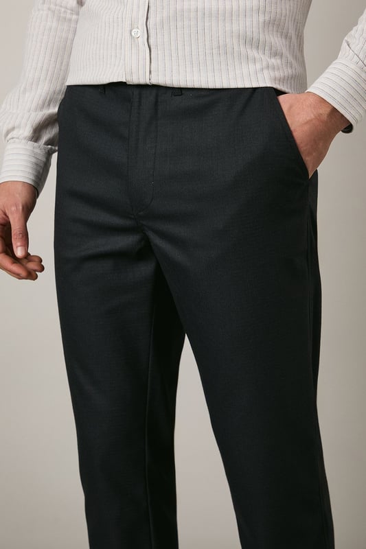 Textured woven fabric with added stretch for enhanced comfort and movement
        Clean-cut straight leg design offering a smart, versatile silhouette
        Side slash pockets for practicality without compromising the sleek appearance
        Rear welt pockets adding refined detail to the tailored look
        Smooth waistband with belt loops for a customised fit
    
    These Maine textured trousers combine sophistication with practicality, making them an essential addition to your smart wardrobe. The subtle texture adds visual interest while the added stretch ensures day-long comfort whether you're in meetings or attending formal gatherings. Style them as shown with a light-coloured button-down shirt for a crisp office look, or pair with a fine knit jumper for smart-casual occasions. The versatile straight leg cut works brilliantly with both formal shoes and white trainers for a contemporary twist on traditional tailoring. Perfect for work environments, important presentations, or evening events where you need to convey polish without appearing overdressed. These trousers transition effortlessly from day to evening, maintaining their shape and smart appearance throughout.