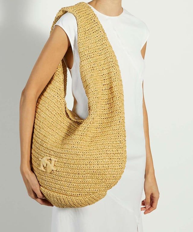 Dune Accessories Dangerous - Logo Raffia Shopper Book, bottle, mobile phone...this unlined woven raffia shoulder bag profile is the perfect addition to beach days and weekend getaways. Featuring our signature interlocking double D logo wrapped in raffia to complement the bag, this stylish summer accessory comes with an internal unlined raffia pouch to store valuables.