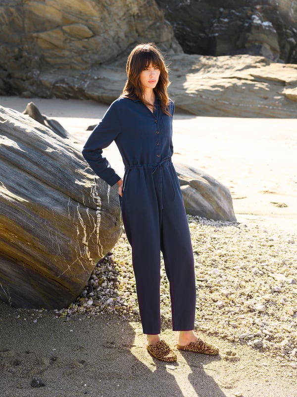 With a collared neckline and relaxed fit, this jumpsuit features a drawstring waistband for an adjustable silhouette. Crafted from  cotton, it provides both comfort and versatility, making it a go-to choice for effortless day-to-night dressing.