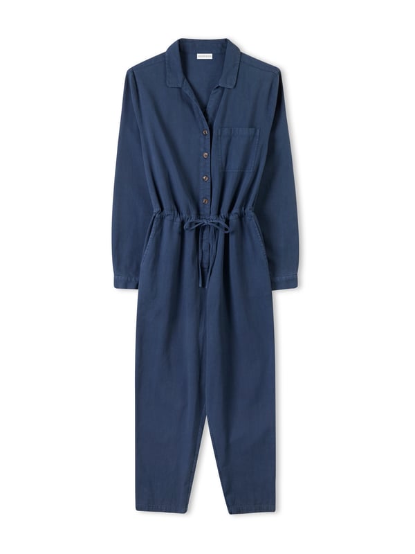 With a collared neckline and relaxed fit, this jumpsuit features a drawstring waistband for an adjustable silhouette. Crafted from  cotton, it provides both comfort and versatility, making it a go-to choice for effortless day-to-night dressing.
