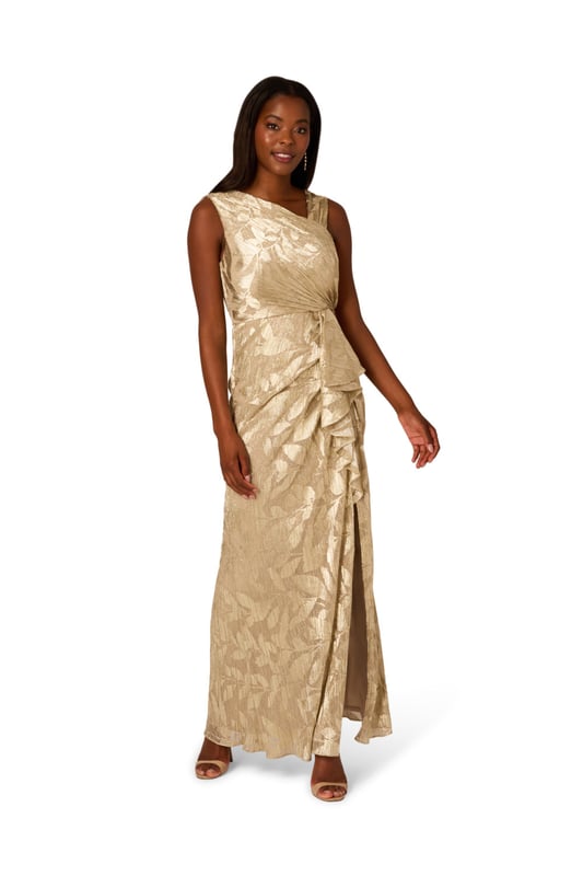 Foil Asymmetric Gown Take your style to the next level with this edgy foiled dress. This formal dress features an asymmetrical neckline, draped details through the body, and ruffle trim at the waist. Crafted from foiled and printed novelty fabric, this sleeveless dress is an eye-catching look with some stretch. A slit at the side of the mermaid skirt and a side zipper closure completes this evening gown. Paired with nude heels and a simple clutch, this printed gown is a charming look.