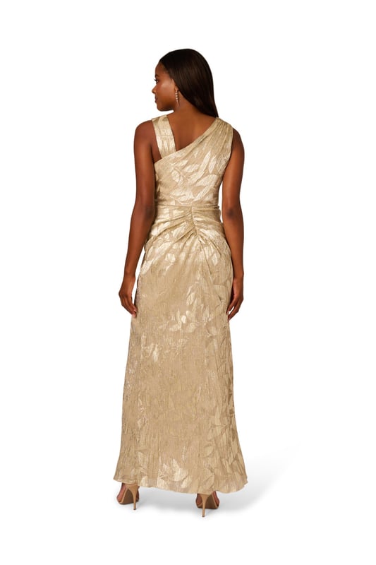 Foil Asymmetric Gown Take your style to the next level with this edgy foiled dress. This formal dress features an asymmetrical neckline, draped details through the body, and ruffle trim at the waist. Crafted from foiled and printed novelty fabric, this sleeveless dress is an eye-catching look with some stretch. A slit at the side of the mermaid skirt and a side zipper closure completes this evening gown. Paired with nude heels and a simple clutch, this printed gown is a charming look.