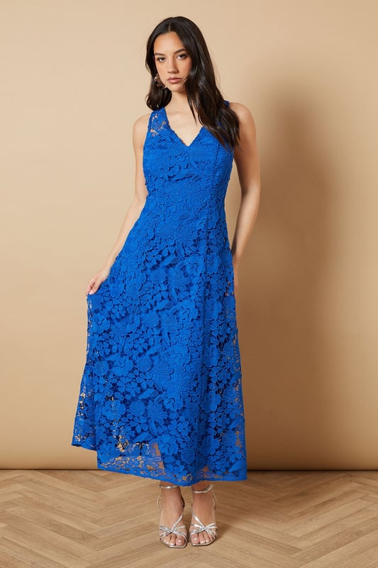 Floral Lace V Neck Midi Dress Intricate floral lace overlay creates a romantic, feminine aesthetic
Flattering V-neckline at front and back for an elegant silhouette
Sleeveless design perfect for warm-weather occasions
Midi length falls gracefully below the knee for sophisticated coverage
Semi-sheer lace detailing adds textural interest and dimension
This enchanting Oasis midi dress showcases delicate floral lace throughout, making it a standout choice for special occasions. The feminine V-neckline frames the dcolletage beautifully, while the matching V-back adds an unexpected touch of allure. Style with metallic strappy heels as shown for formal events such as weddings or race day celebrations. For evening soires, pair with a sleek clutch and statement earrings to complement the dress's intricate texture. The versatile midi length works wonderfully for garden parties when styled with elegant sandals, or dress it up with a tailored blazer for sophisticated evening affairs. This timeless piece transitions effortlessly from daytime celebrations to evening gatherings with just a change of accessories, making it a valuable addition to your occasion wardrobe.