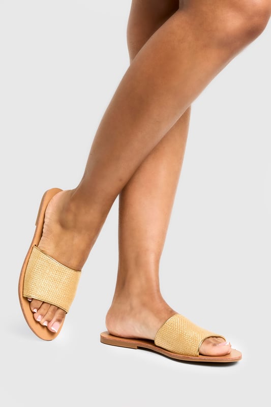 Raffia Mule Sandal Textured bast-style slide sandals with a single wide strap design
Flat heel measuring between 0-2cm for all-day comfort
Open toe silhouette perfect for showcasing pedicures
Slip-on style for effortless wear
Versatile neutral tone that complements any summer outfit
These minimalist bast-style sandals from Boohoo combine simplicity with versatility for your warm-weather wardrobe. The understated design features a comfortable flat sole that's ideal for city exploring or beachside strolls. Style them with cropped linen trousers and an oversized shirt for casual daytime outings, or pair with a flowing maxi dress for family gatherings and garden parties. The neutral tone works brilliantly with bold prints and patterns, making these sandals a true wardrobe staple. For festival season, match them with denim shorts and a graphic tee, adding layered jewellery for a touch of bohemian flair. Their lightweight construction makes them perfect for packing in your holiday suitcase, whilst the durable sole ensures they'll remain a favourite throughout the summer months.
